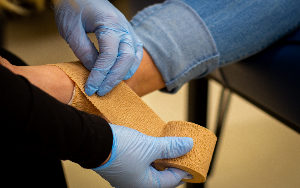  hands wrapping an ankle